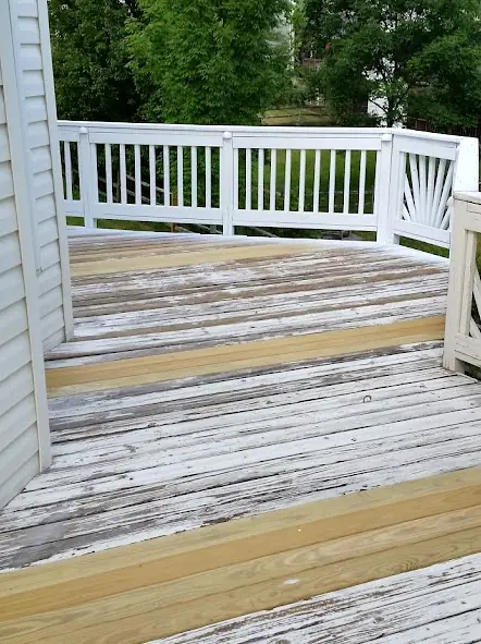 After: The same deck with new pressure-treated boards installed alongside the old decking
