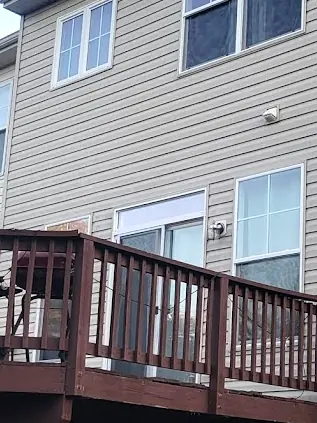 After: The same townhouse siding after house washing, with the algae removed